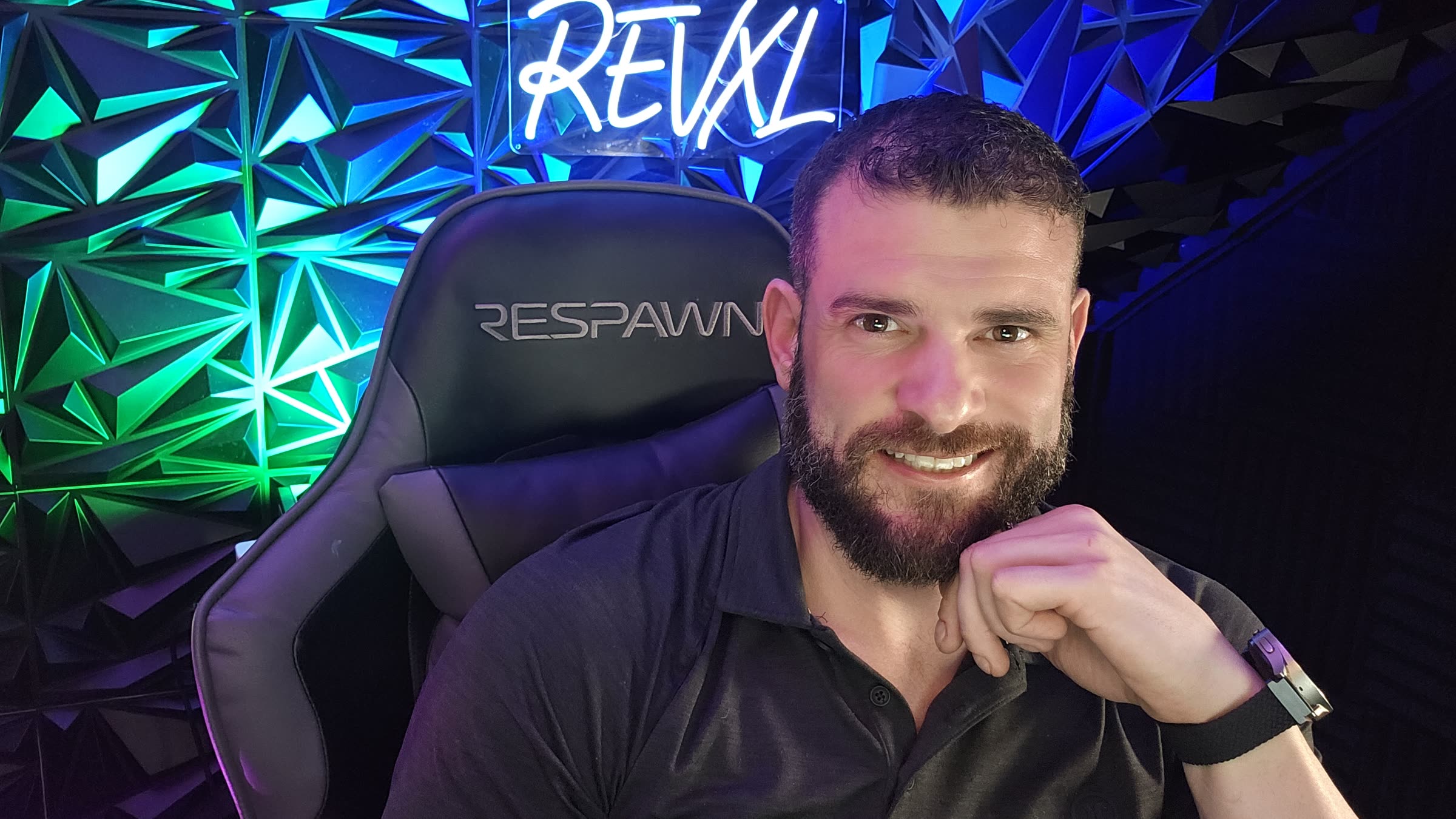 Joe Olive, AI systems builder, in front of the REVXL sign